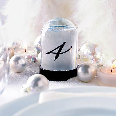 Put table numbers in snow globes for winter wedding